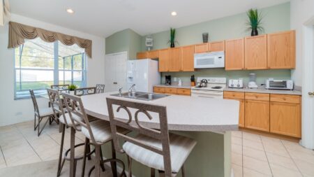 Kitchen with a breakfast bar and small dining table.