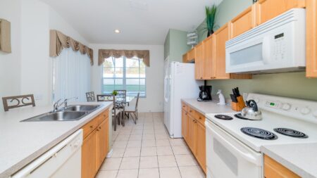 A close view of the kitchen appliances overlooking the dining table.