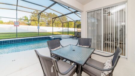 Outdoor dining area with a view of the pool.