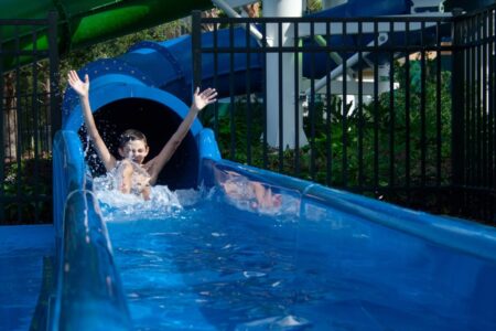 Child laughing at bottom of waterslide