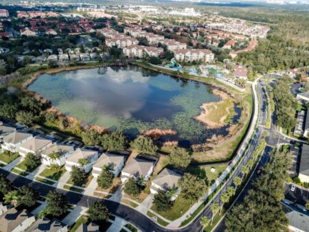 Ariel image of lake, villas and waterpark at Windsor Hills Resort in Kissimmee.